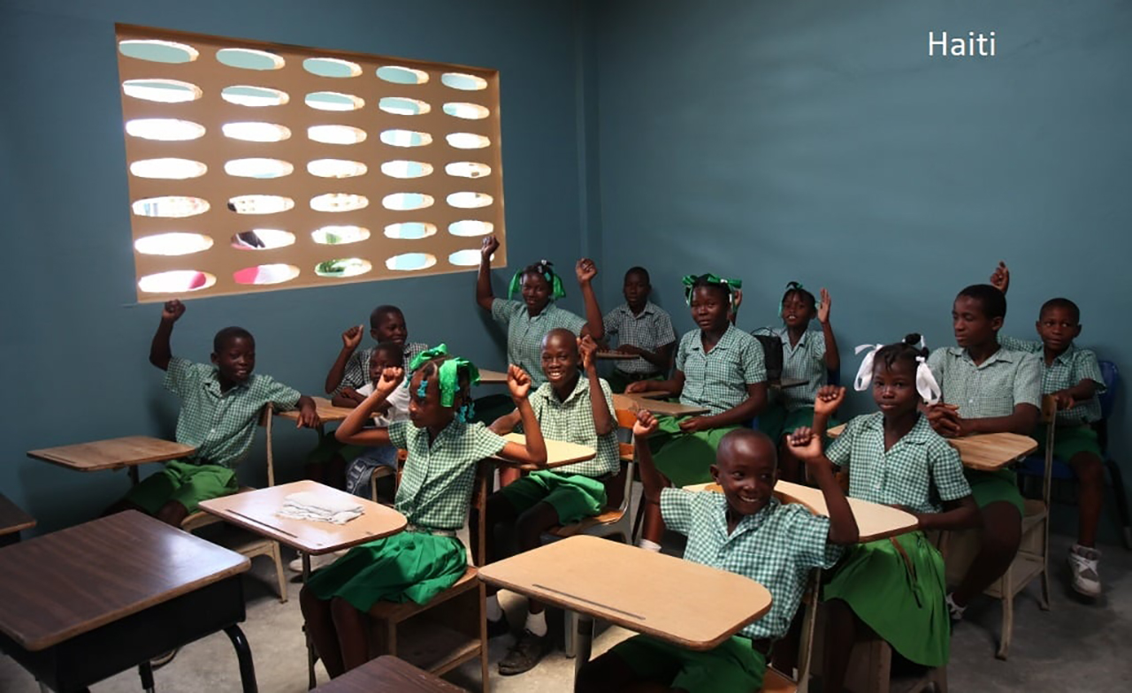 Students in Haiti with donated furniture; photo from IRN